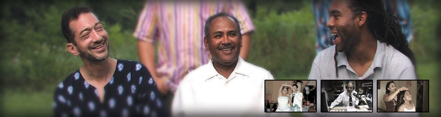 Three men of color are sitting in a field, looking at each other while talking and laughing.